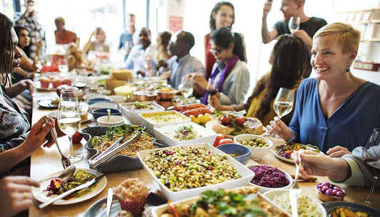 Enjoying a festive meal with friends and family, sharing holiday health tips for a healthier season.