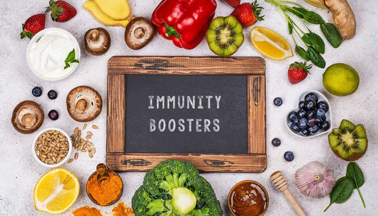 Healthy foods and a chalkboard labeled 'Immunity Boosters' to boost immune system flu season.